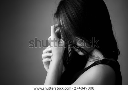 Black and white portrait of worried woman on white background