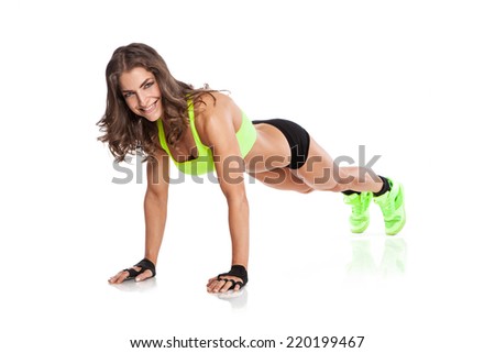 beautiful fitness young woman doing push ups isolated over white background