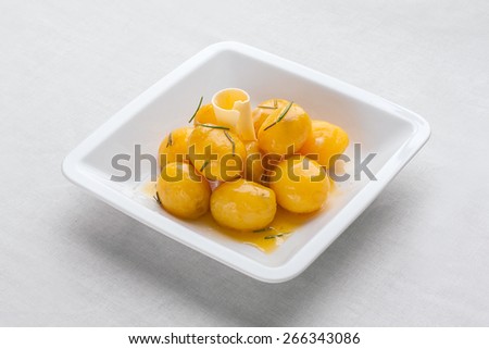 Small new boiled potatoes tossed with fresh herbs in olive oil