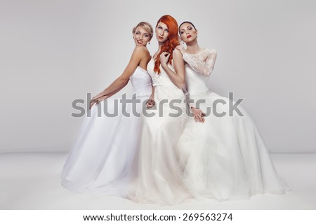 portrait of a three beautiful woman in wedding dress isolated over white background