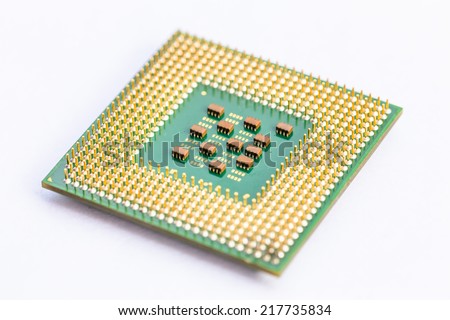 Close-up of a computer processor microchip between the fingers and isolated on a white background