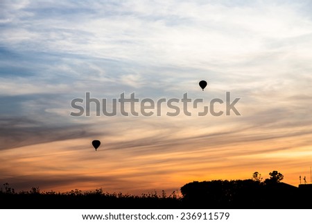 Hot air balloon fly up in the air with silhouette environment
