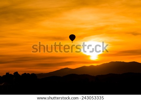 Hot air balloon fly up in the air with silhouette environment