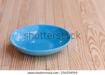 empty earthenware plates on wooden tabletop