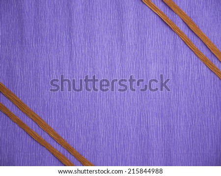A blue crepe paper background with 2 red parallel lines at 2 opposite corners