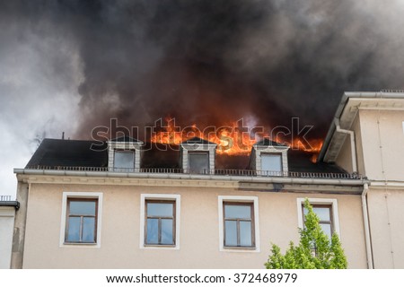 Close view of flames in an upper story window