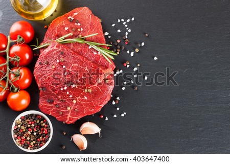 Raw steak with spices and ingredients for cooking. Top view