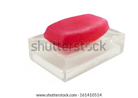 Classic red soap on a semi transparent soap dish isolated on white