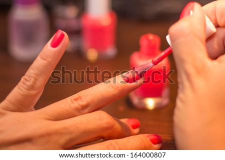 Red finger nails painting
