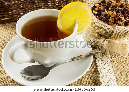 Hot cup of tea and dry herbal leaves