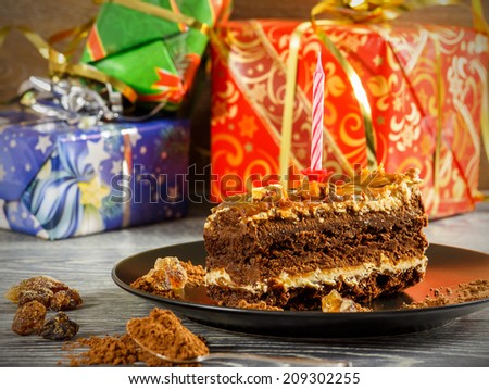 Birthday cake with presents in the background
