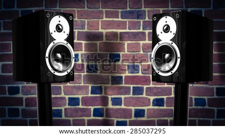 Black music speakers against brick wall background