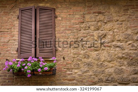 Brown window shutters and purple decorative flowers