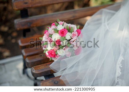 Bridal bouquet from white and pink roses in the bride\'s hands