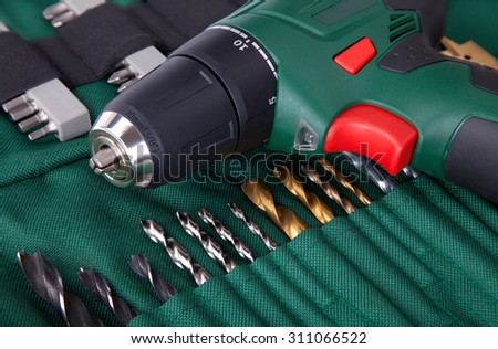 Set cordless screwdriver and bits. Hand tools for assembly work.