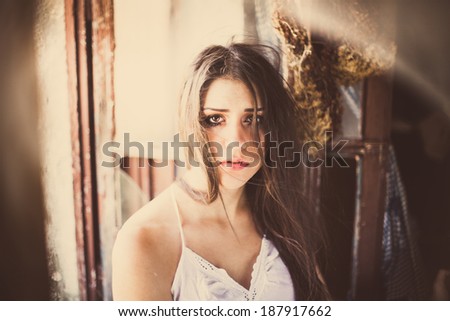 Brunette abused sad crying woman portrait in old ruined house