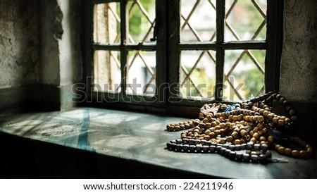 Muslim rosary beads on the mosque window, holy place of muslims. Islam prayer beads. Beads for praying