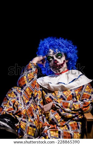 Crazy ugly grunge evil clown in town on Halloween making people shock and scared. Crazy ugly grunge evil clown. Scary professional Halloween masks. Halloween party