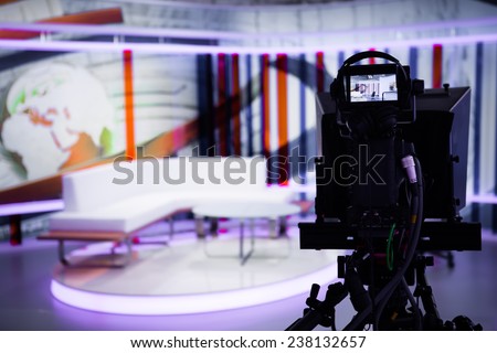 TV morning program studio with camera and lights. Video camera lens - show in TV studio. Television studio with interior and and positioned camera .