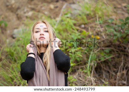 Beautiful young blonde woman with gemstones on her forehead.Yoga woman,healthy spiritual woman with veil/ scarf.Calm mysterious beauty woman.