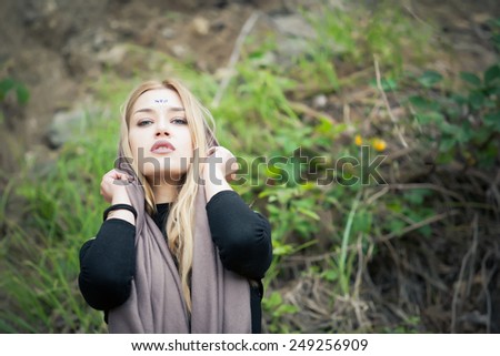 Beautiful young blonde woman with gemstones on her forehead.Yoga woman,healthy spiritual woman with veil/ scarf.Calm mysterious beauty woman.