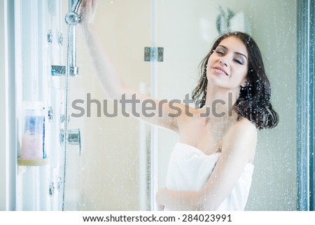 Beautiful sexy woman in towel after shower.Relaxation of young woman taking shower.Relief after long stressful day.Taking moment for yourself concept.Skincare,spa and aromatherapy.