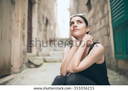 Thinking woman standing pensive contemplating.Thinking woman looking up.Challenge concept.Young brunette looking curious.Smiling content European woman.Pretty face girl ready for future adventures