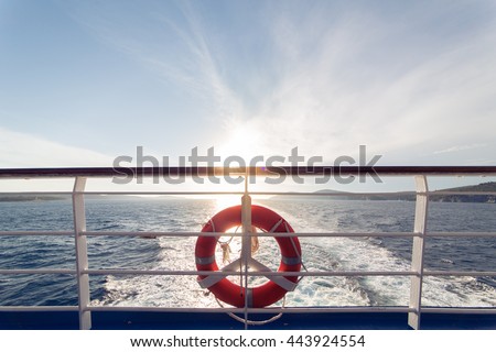 Ring life boy on big boat.Obligatory ship equipment.Personal flotation device.Prevent drowning.Orange lifesaver on the deck of a cruise ship.Traveling to an island