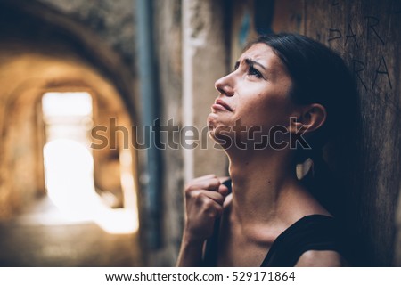 Woman with sad face crying.Sad expression,sad emotion,despair,sadness.Woman in emotional stress and pain.Woman standing alone on the street, after a fight with boyfriend.Relationship and love problem