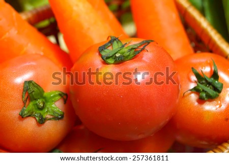 Fresh tomatos ,carrots on a bamboo tray