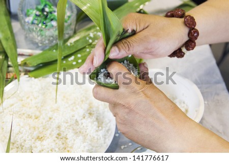 Making traditional chinese rice-pudding or zongzi