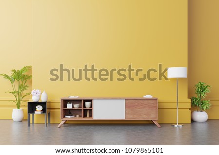 Cabinet TV in modern living room with lamp,table,flower and plant on yellow wall background,3d rendering