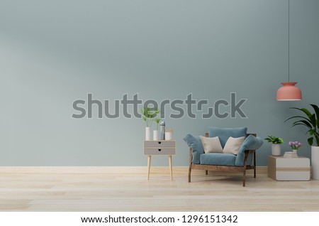 Modern living room with blue armchair have cabinet and wood shelves on wood flooring and blue wall ,3d rendering