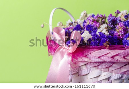 basket of flowers isolated on green background