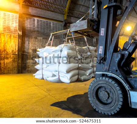 sugar in bags handling to stacking in warehouse by forklift.