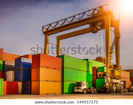 The RTG(Rubber Tried Gantry Cranes) pick up full loaded containers on truck at industrial port and container yard   for delivery to customers