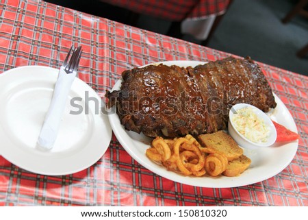 Rib meat set served with curly fried, bread, salad, watermelon