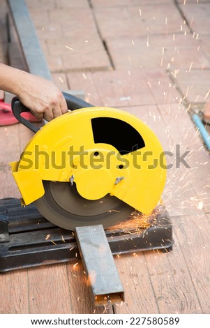 blade of cutter machine is cutting a bar of steel