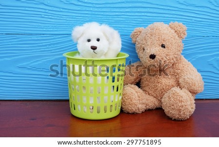 white bear in green bin next to brown bear