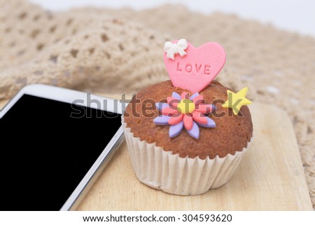 Cup cake decoration and mobile phone