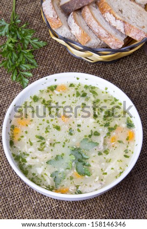traditional barley soup in a white bowl with bread