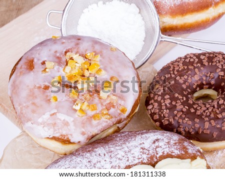 donuts with icing, powdered sugar and chocolate