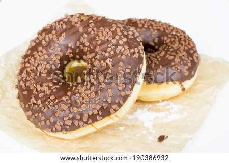 donuts with chocolate on baking paper