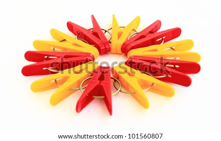 yellow and red  clothes peg isolated on a white background.  Five reds and five yellow clothespins located on a circle.