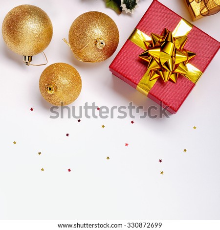 Christmas decoration isolated white. Red and golden gift boxes with three golden ball, and floral ornament. Top view. Square composition.