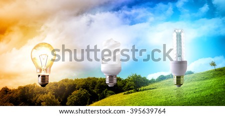 Comparison between various types of light bulb on landscape background. CO2 emissions and environmental conservation. Horizontal composition. Front view