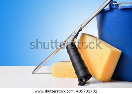 Window cleaning tools on white table. Front view. Horizontal composition