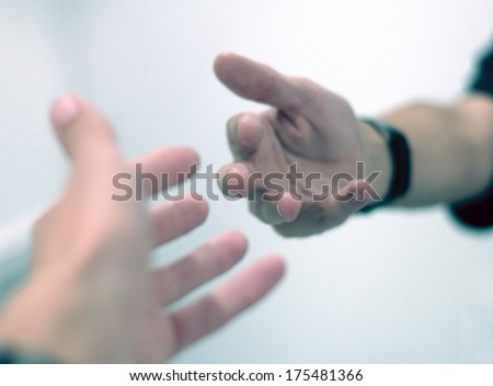 Hands reaching out to each other.