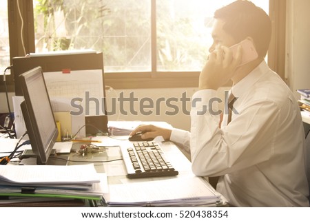 BUSY MAN, Male freelancer use PC sitting in modern loft interior with big windows, confident business man busy using PC at office desk, teacher typing on computer while sitting at cluttered table