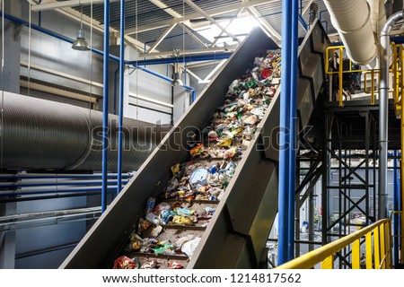 moving conveyor transporter on Modern waste recycling processing plant. Separate and sorting garbage collection. Recycling and storage of waste for further disposal.